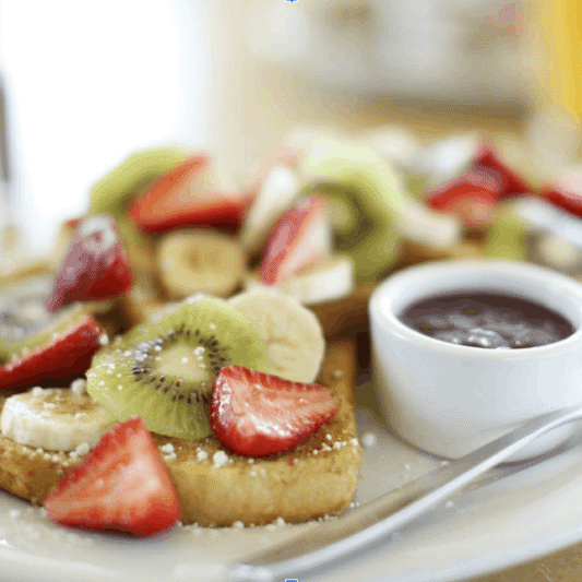 Breakfast plate with fresh fruit, toast and coffee