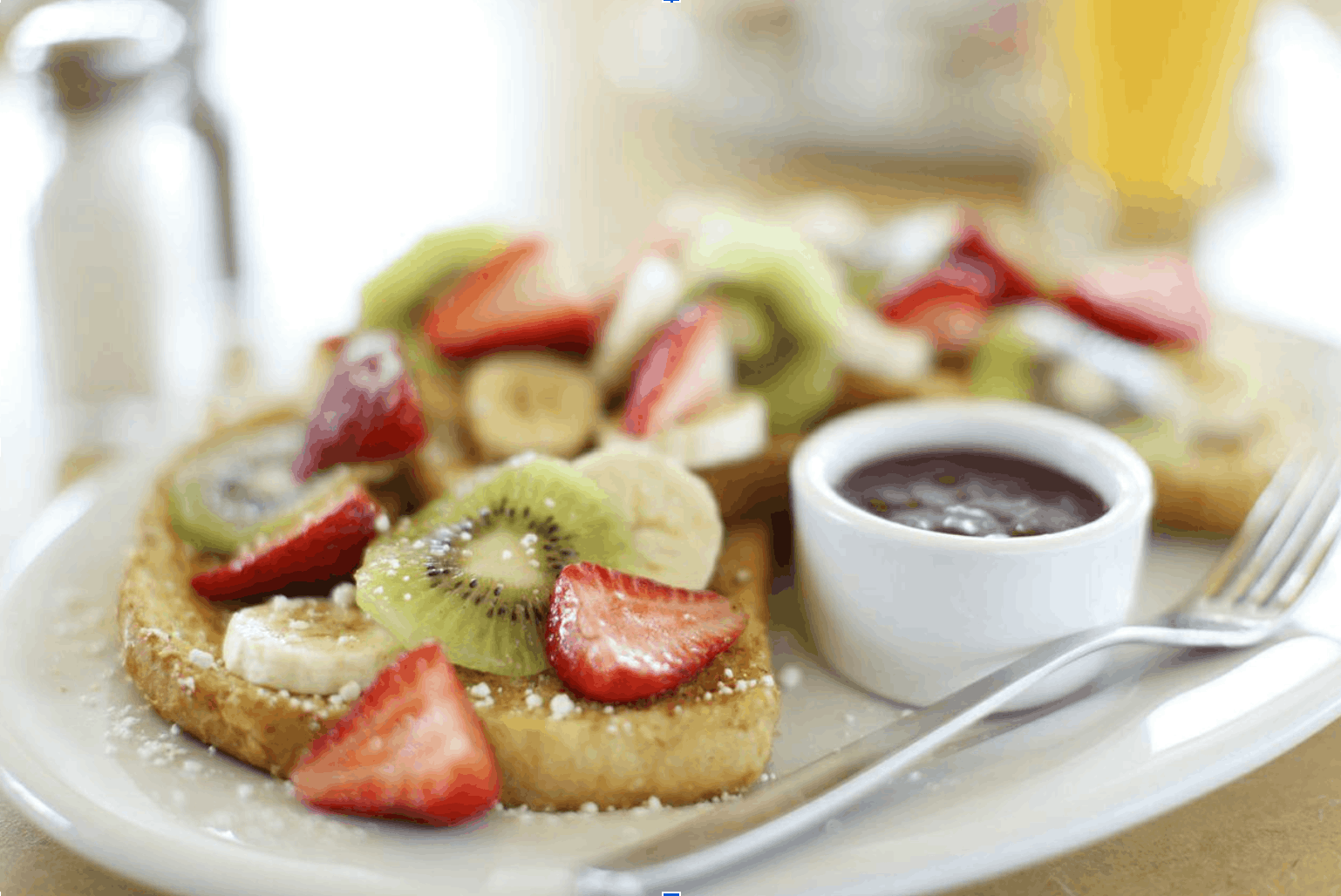 Breakfast plate with fresh fruit, toast and coffee
