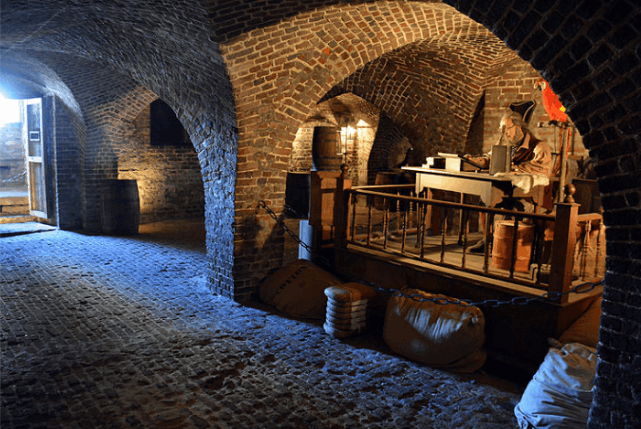 A historical exhibit inside the underground brick vaults of the Old Exchange and Provost Dungeon in Charleston, South Carolina.