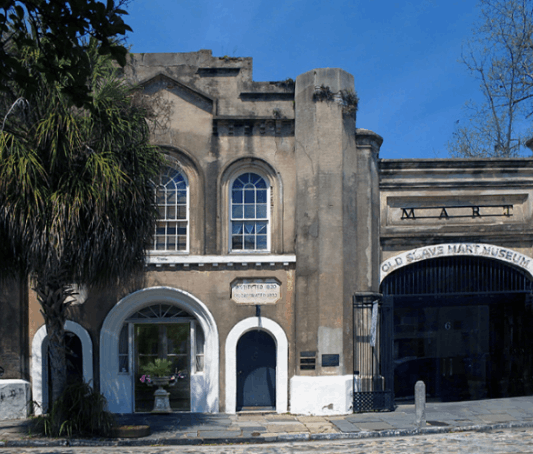 Exterior facade of the historic Old Slave Mart Museum on Chalmers Street in Charleston, South Carolina.
